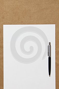 Template of white paper with pen lies on light brown cloth background. Concept of business plan and strategy. Stock