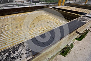 Templates and formwork for cement pouring. Concrete plant. Workers in the workshop of the House-building plant