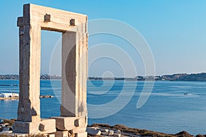 Temple of Apollo ancient ruins in Naxos island, Cyclades, Greece. Famous landmark of Portara with Aegean sea background.