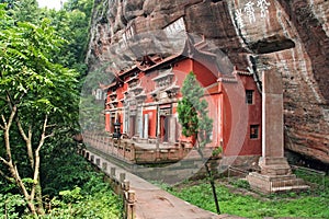 Temple building leaning against a vertical rock in Qiyun Taoist