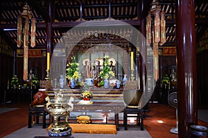 Temple in cloister of Thien Mu Pagoda with three Buddhas, Hue City, Vietnam