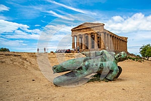 Temple of Concordia and the statue of Fallen Icarus, in the Valley of the Temples, Agrigento, Sicily, Italy