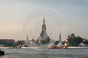 Temple of Dawn at sunrise. Popular Bangkok tourist destination landmark