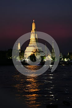 The temple of Dawn or Wat Arun on the bank of the Chao Phrya river after sunset, Bangkok, Thailand