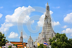 The Temple of Dawn or Wat Arun Buddhist temple with a beautiful blue sky and clouds background