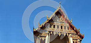 Temple gable soaring into blue sky