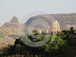 Temple on a hill top in nashik, Maharashtra with Plateaus in background photo