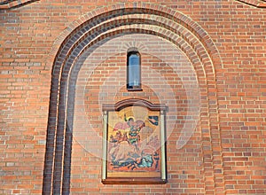 Temple icon in an arched niche on the facade of the chapel of St. George the Victorious. Kaliningrad