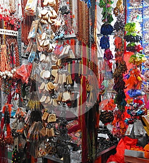 Temple side shops selling colorful beaded garland, key chains, wristlet