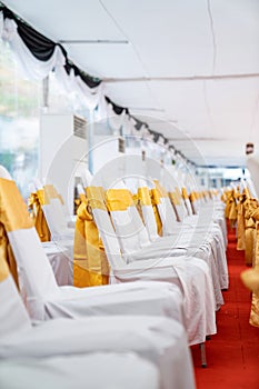 Temporary Air Conditioner indoor tent for outdoor event in the day. Inside Tents has red carpet and a lot of chair covered by