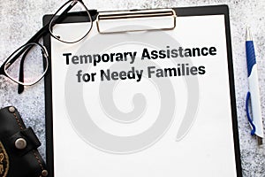 Temporary Assistance for Needy Families TANF is shown on a photo using the text. photo