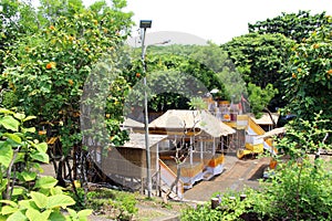 Temporary buildings covered by yellow clothes around Uluwatu for ceremony. Taken January 2022