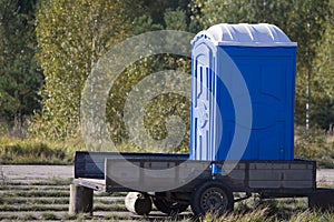 Temporary cabin toilet on a trailer in the woods