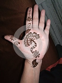Temporary henna tattoo on woman& x27;s hand