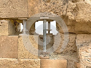 Temporary steel pillars support an ancient stone wall