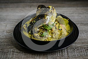 Tempoyak ikan patin with green gravy.