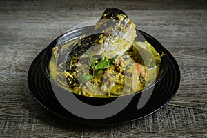 Tempoyak ikan patin with green gravy. photo