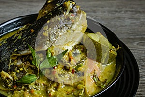 Tempoyak ikan patin with green gravy. photo