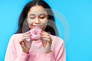 Temptation food. Pretty black woman enjoy donut