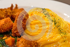 A tempting and delicious Japanese curry fried chicken omelet rice