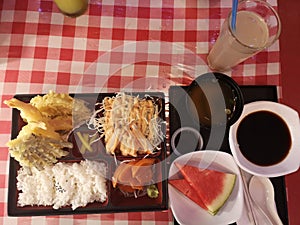 Tempura bento box with white rice and salmon sashimi