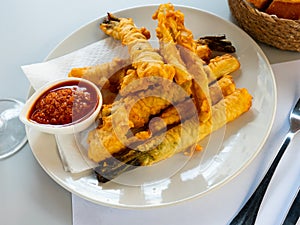 Tempura fried calcots served with Romesco sauce