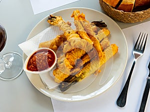 Tempura fried calcots served with Romesco sauce