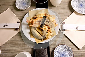 Tempura in Japanese Food Restaurant â€“ Plate with Vegetables and Shrimps Fried in Batter, Chopsticks, Ceramic Plates