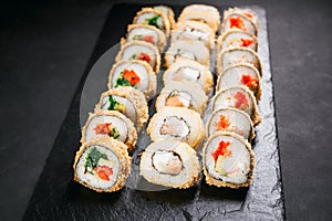 Tempura maki. Japanese sushi rolls set on slate