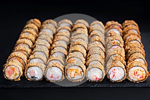 Tempura maki sushi rolls set on black slate