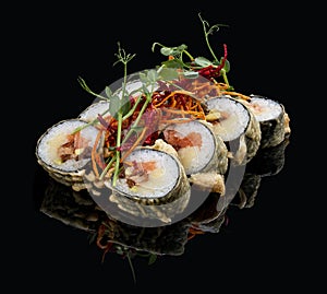 Tempura roll with salmon and tuna on glossy black background. Deep fried