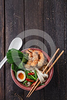 Tempura shrimps with asian noodle soup in a bowl