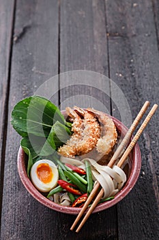 Tempura shrimps with asian noodle soup in a bowl