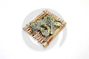 Temuras ofwild vegetable called Taranome on the raft shaped bamboo tableware