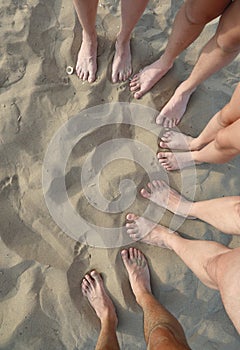 ten barefoot of a family of five on the sand