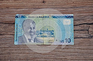 A ten dollar Namibia banknote on a wooden background