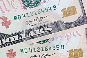 Ten dollars bills close up consecutive serial numbers