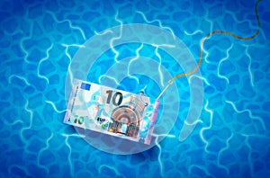 Ten euro banknote on glossy silver metal fishing hook in a blue shiny water, fraud concept