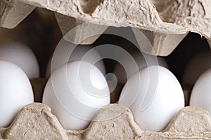 Ten fresh white eggs in a container