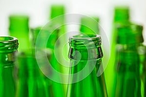 Ten green bottle necks on white background.