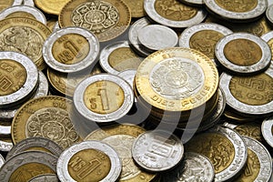 Ten Mexican Pesos Coin on a Pile of Mexican Coins photo