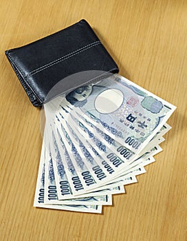 Ten peices of one thousand Japanese cashes wallet close up