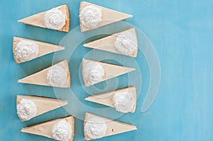 Ten pieces of cheesecake on a blue background, top view, like sweet, sweet tooth,