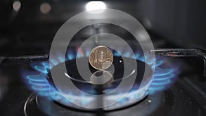 ten-ruble coin in a fire on the burner of the gas stove. the energy crisis.