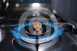 ten-ruble coin in a fire on the burner of the gas stove. the energy crisis.