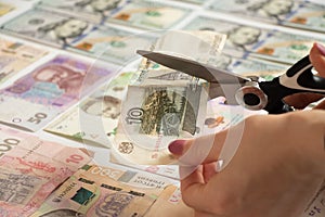 Ten rubles cut with scissors against the background of money, the default of the Russian