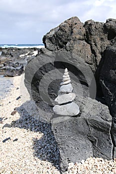 A ten stone cairn at the edge of an ocean