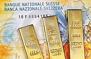 Ten Swiss Franc bank note with three gold bars