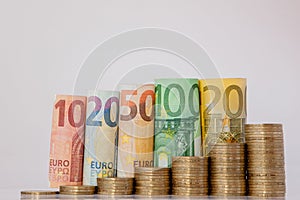 Ten, twenty, fifty, one hundred, two hundred and coins euro rolled bills banknotes on white background. Histogram from the euro.