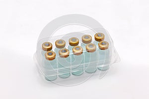 Ten vaccine bottles inside closed translucent plastic box